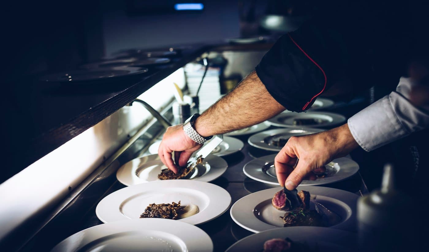A chef carefully finishing a dish